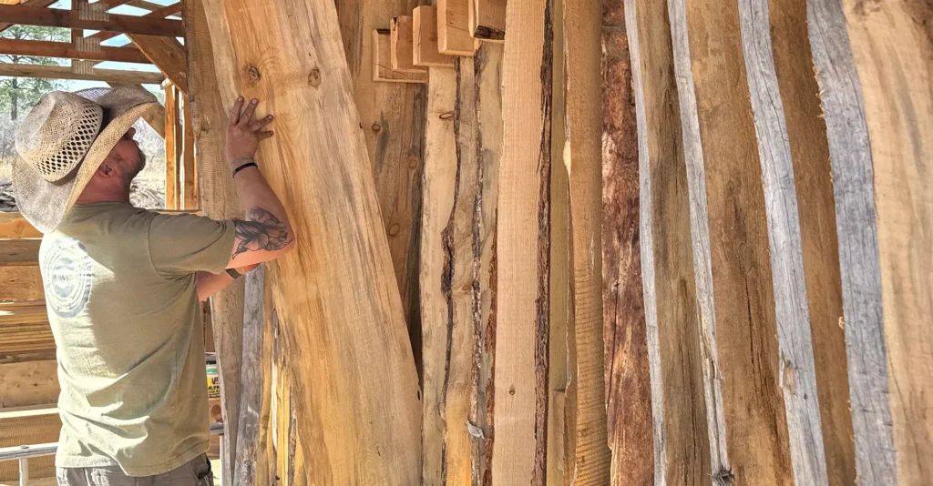John Christenson stacking rough sawn boards